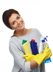 Beautiful  woman in gloves holding different cleaning stuff