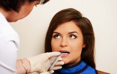 Dentist making x-ray picture of a happy female patient