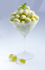 Frozen grape in martini glass.