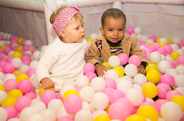 Fototapeta na wymiar Happy children in colored ball on birthday on playground