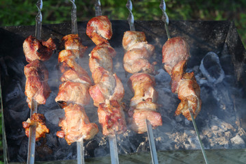 Delicious crispy appetizing barbecues grilled over burning coals