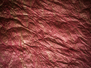 Dark red and golden crumpled paper texture