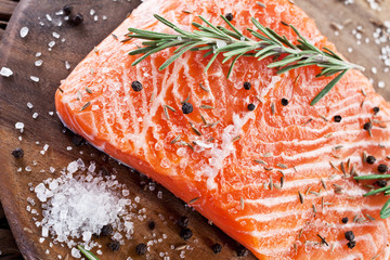 Salmon filet on a wooden carving board.
