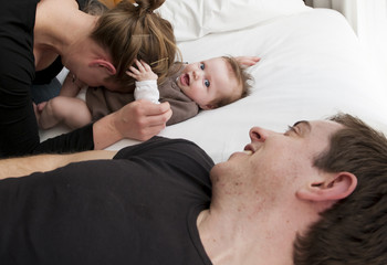 Young mother playing with sweet baby girl