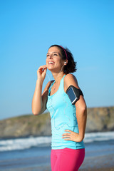 Fitness woman with sport band listening music