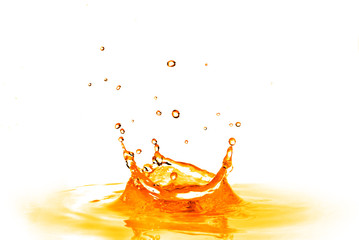 drop falling into orange water with splash isolated on white