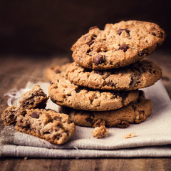 Chocolate cookies on white linen napkin on wooden table. Chocola