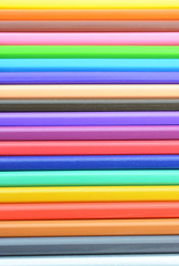Collection of colored pencils forming a background