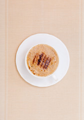 Cup coffe hot beverage drink with froth on brown background