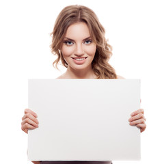 Fototapeta premium Portrait of a cheerful young blond woman holding a white blank b