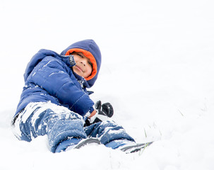 Fototapeta na wymiar Little Boy Playing in the Snow
