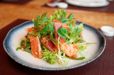 Appetizer with rare fried tuna and salmon in plate