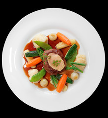 Tenderloin steak with vegetables and bone marrow isolated on bla
