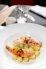 Chicken breast with potatoes on plate