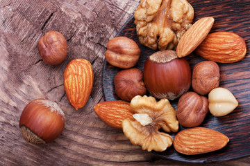 Nuts on wooden background.