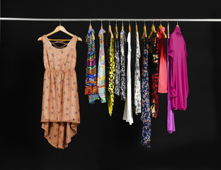 Female Variety of evening gown clothes hanging on the rack