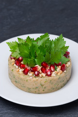 white bean pate with nuts and pomegranate seeds, vertical