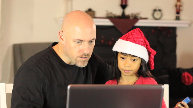 Dad And Daughter Shop Online For Christmas Gifts