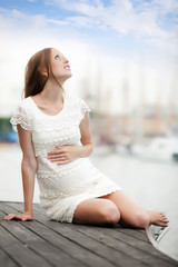 Fototapeta na wymiar dreaming pregnancy woman at sea port