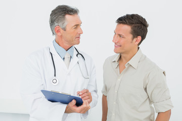 Doctor discussing reports with patient in office