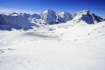 Winter mountains - ski slopes in Italian Alps