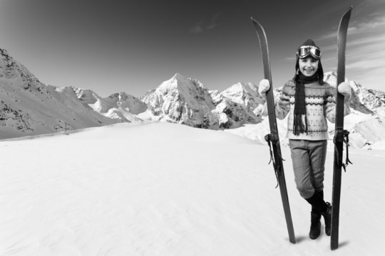 Ski, winter vacation - girl with retro ski equipment
