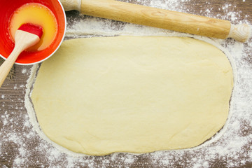 Cinnamon roll dough ready to be brushed with melted butter