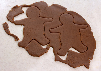 Two gingerbread men in cookie dough