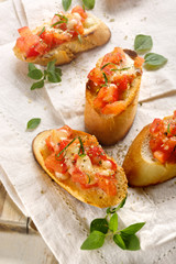 Tomato crostini with mozzarella and oregano