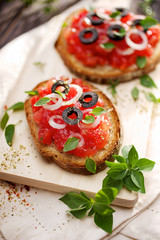 Bruschetta with  tomato, olives, onion and oregano