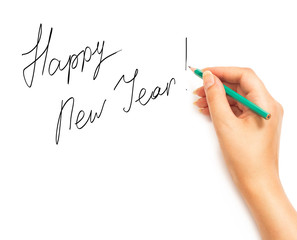 Woman's hand holding a pencil and writing Happy New Year on a wh