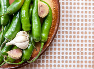 green chili peppers and garlic cloves