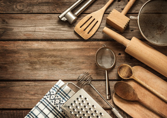 Rural kitchen utensils on vintage planked wood table