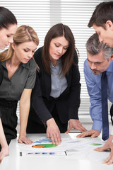 Serious business team having brainstorm in modern office