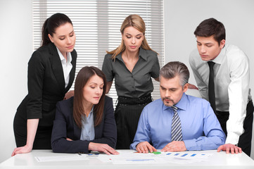Business meeting  of five business people different age.