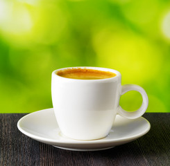 Cup of coffee on nature background