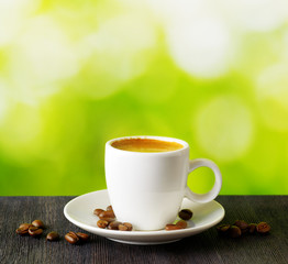 Cup of coffee on nature background
