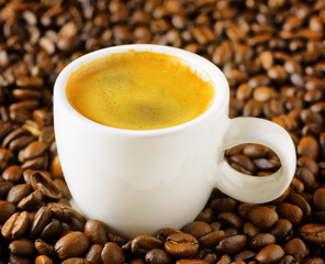 Cup of espresso in coffee beans