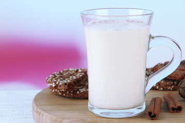 Cup of eggnog with cinnamon and cookies