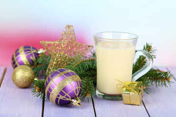 Cup of eggnog with fir branches and Christmas decorations