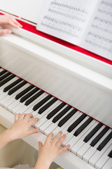 Fototapeta premium Close up of hands playing piano