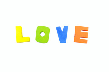 rough edged wooden blocks color spelling out the word love