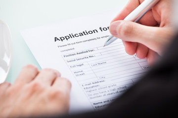 Person's Hand Filling Form