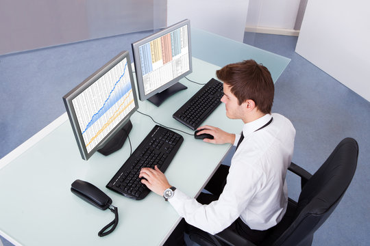 Stock Broker Using Computer At Desk