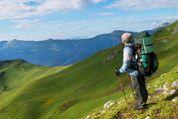 hiker with backpack in a mountains