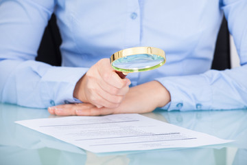 Businesswoman Holding Magnifying Glass
