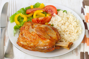 pork with rice and salad on white plate