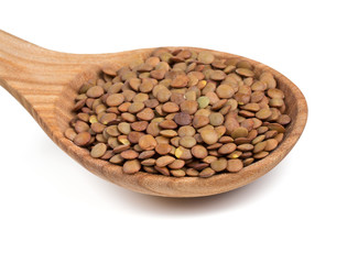 brown lentils in a wooden scoop