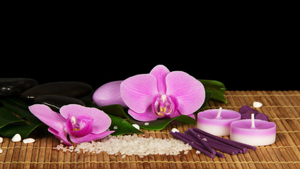 Obraz na płótnie Canvas Orchid flowers, set for Spa on the bamboo cloth