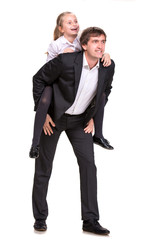 Little girl enjoying piggyback ride with her father